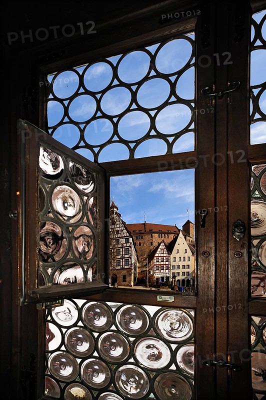 Pilatushaus building seen through a window of Albrecht Duerer House