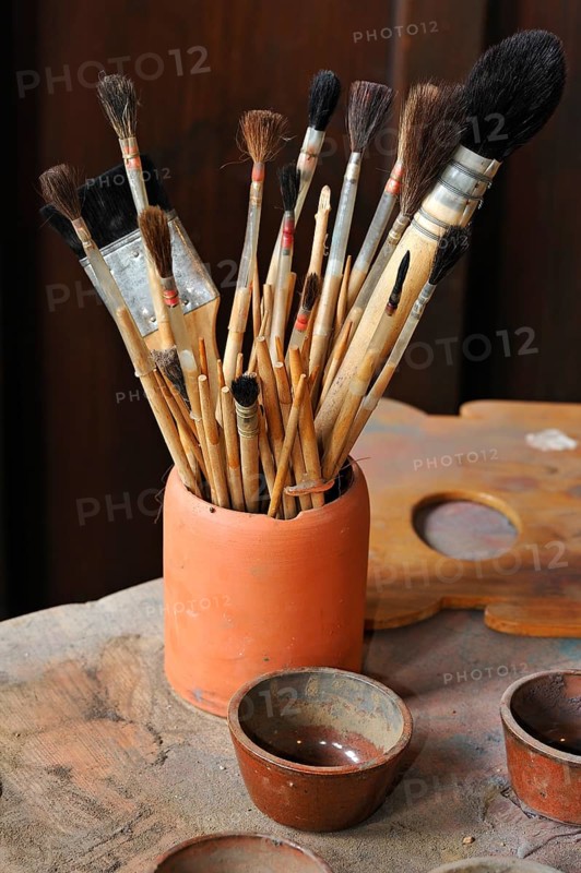 Various hair brushes in a cup