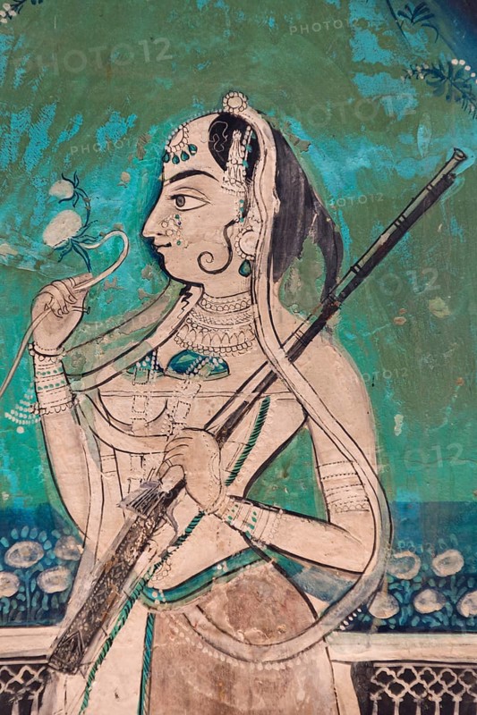 Woman holding a gun and a flower