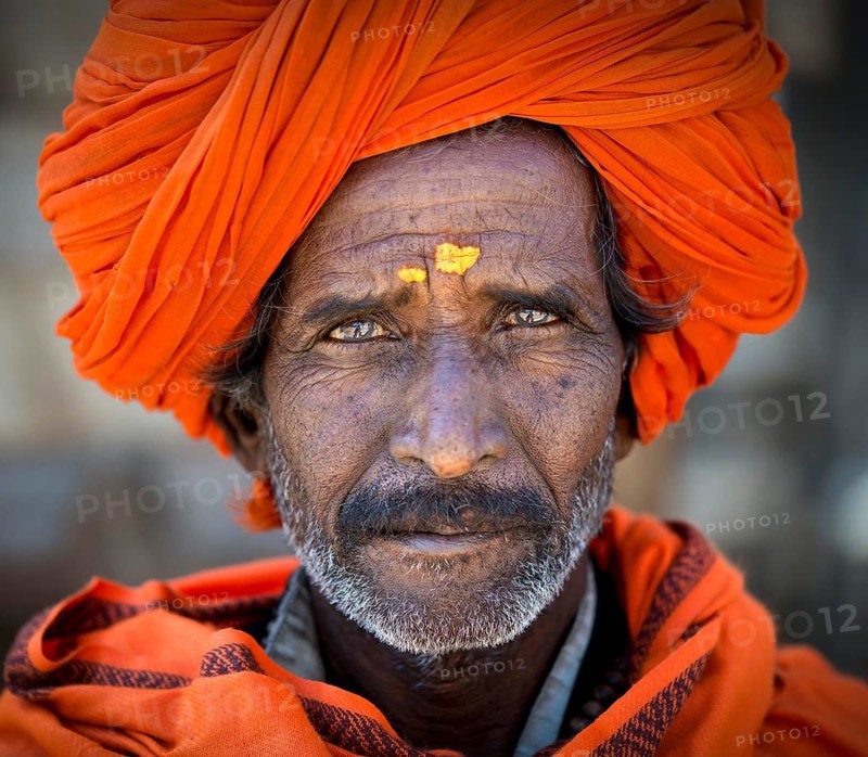 Man with and orange turban and yellow bindi on his forehead