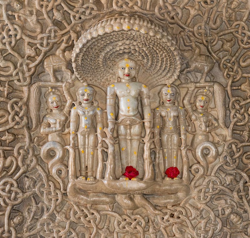 Tirthankar Parshvanat in the medallion protected by the thousand-headed serpent God Dharanendra against a powerful storm