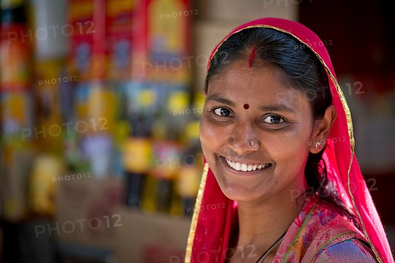 Smiling Indian woman wearing a dupatta scarf with a bindi