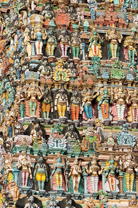 Colourful statues of gods and demons on the Gopuram or Gopura gate tower