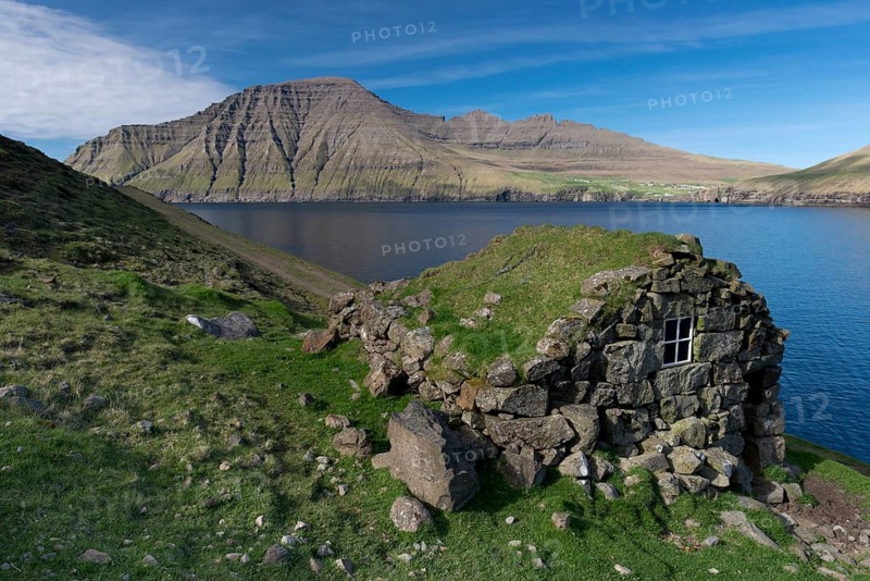 Old stone house on a fjord