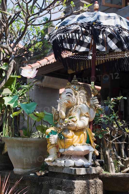 Stone figure of Ganesha with an umbrella