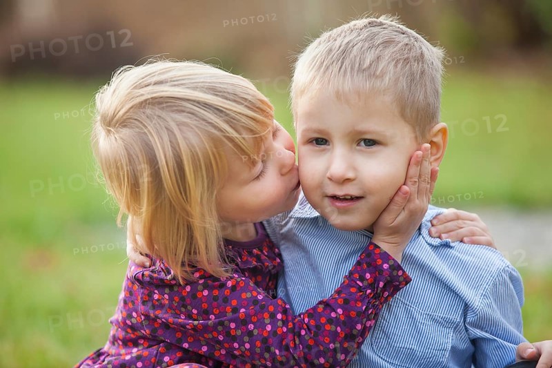 Little girl kissing a little boy