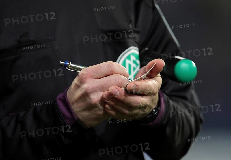 A German assistant refereee taking notes