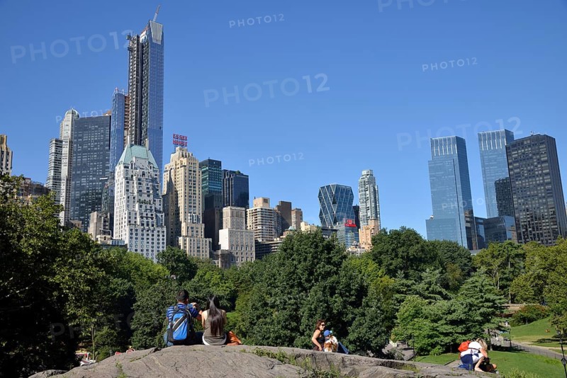 Park visitors with apartment buildings on Central Park South
