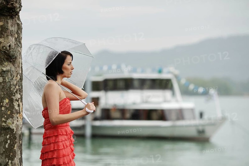 Woman with umbrella outside in a summer rain