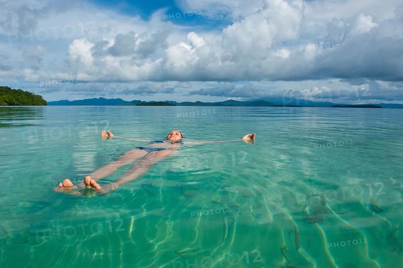 Tourist floating in the clear water of the Marovo Lagoon