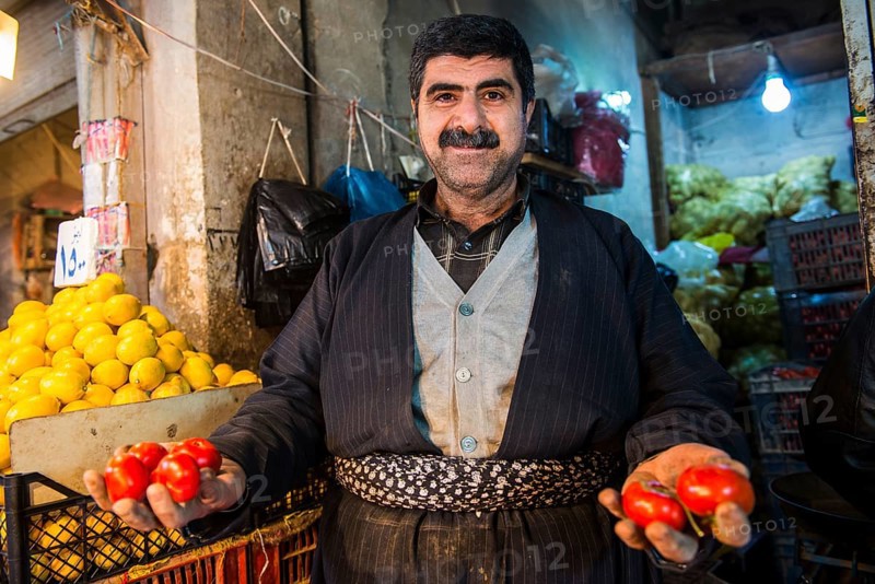 Vendor selling tomatoes in the bazaar of Sulaymaniyah