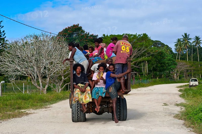 Fully loaded tractor transporting field workers