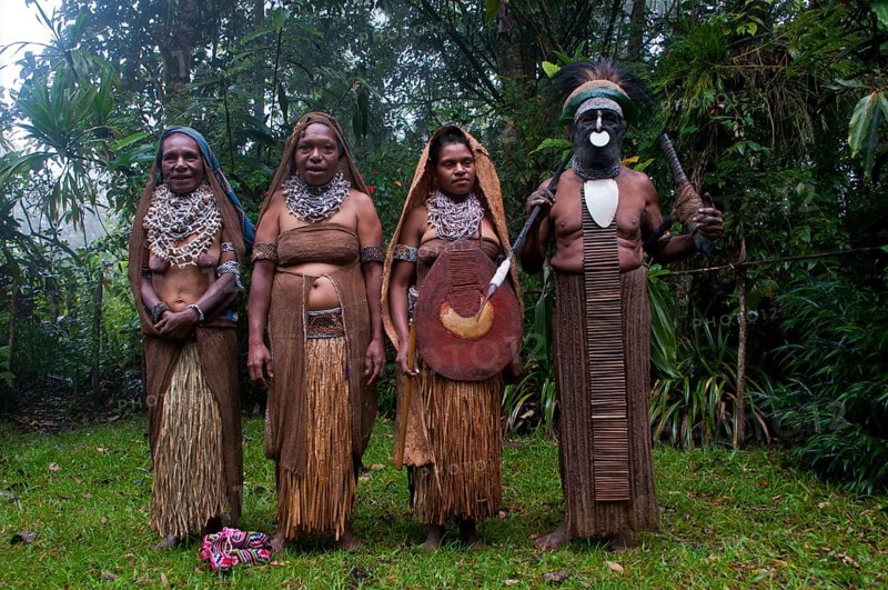 Tribal chief and three women wearing traditional dresses