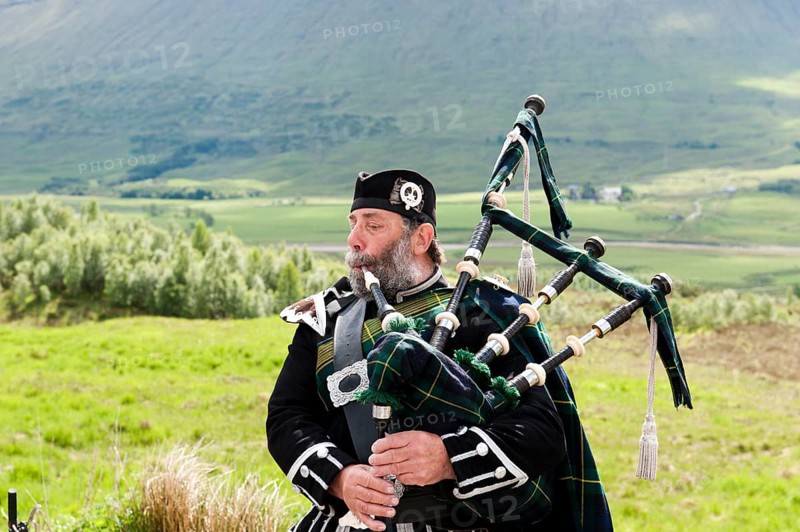 Bagpiper in the Scottish Highlands