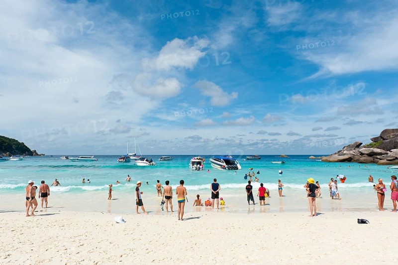 Tourists and boats on the white sandy beach of Ao Kueak