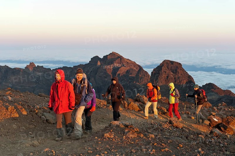 Group of hikers on a hiking trail just before the summit of Piton des Neiges Mountain