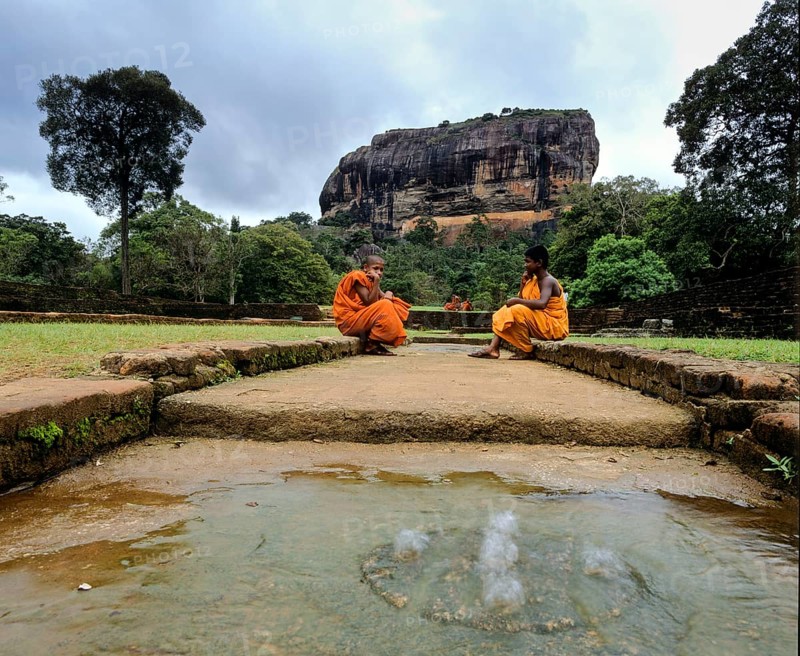 Monks sitting at the cistern