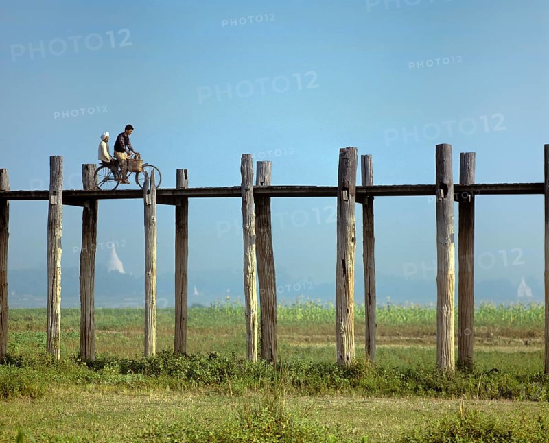 Cyclist on a teak bridge