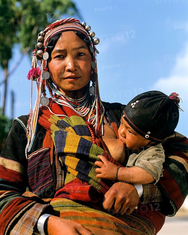 Young Akha woman breastfeeding baby
