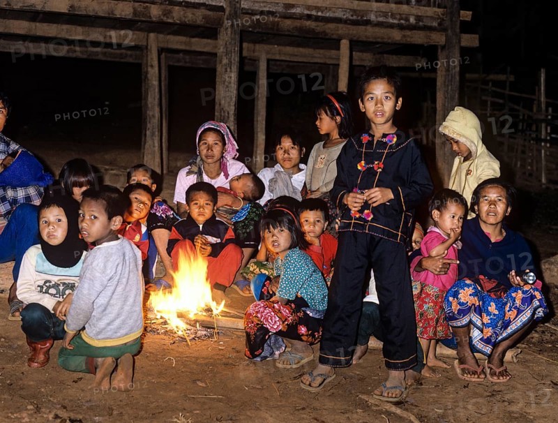 Lahu children sitting around a campfire in a mountain village