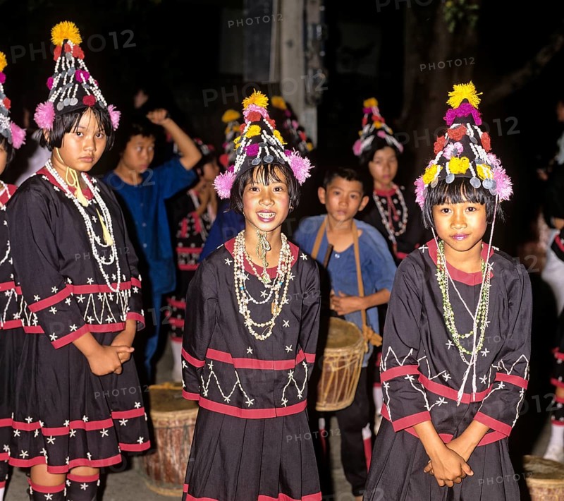 Lahu girls in a mountain village with in traditional costume and headdress
