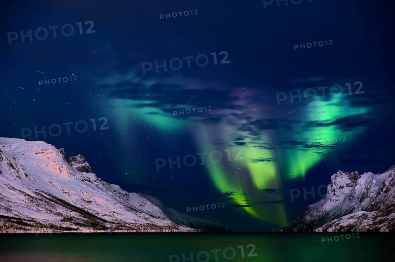 Aurora over fjord with snowy mountains
