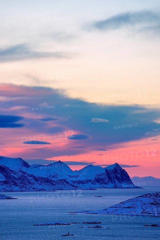 Fjord with mountains in winter at sunset
