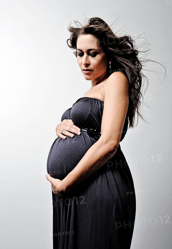 Woman with a pregnant belly wearing a dress