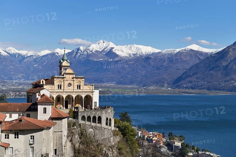 Sanctuary of the Madonna del Sasso or Our Lady of the Rock looking over Lake Maggiore towards snow-capped mountains