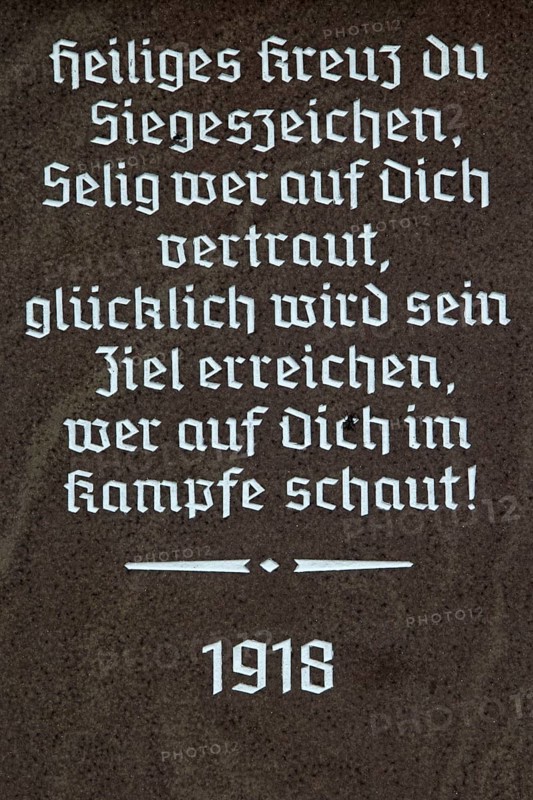 Religious inscription on the base of a wayside cross