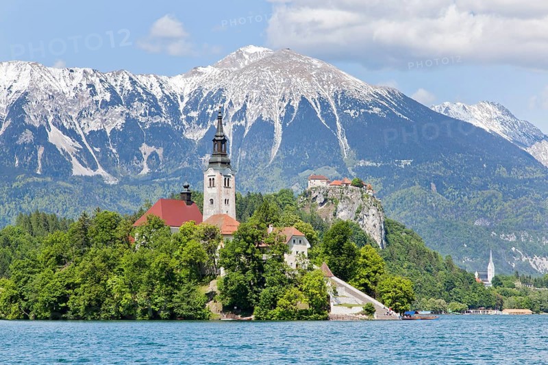 Blejski Otok Island with St. Mary's Church in Lake Bled and The Karawanks mountain range in Bled