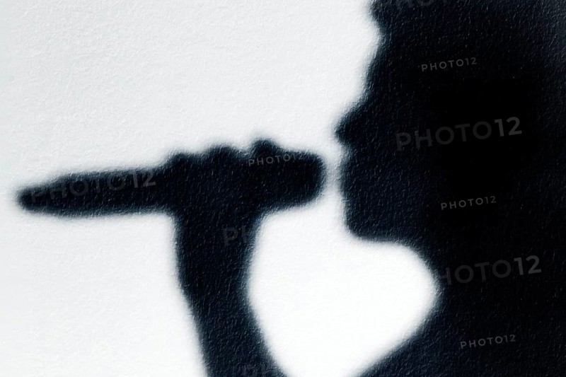 Shadow of a singer with microphone