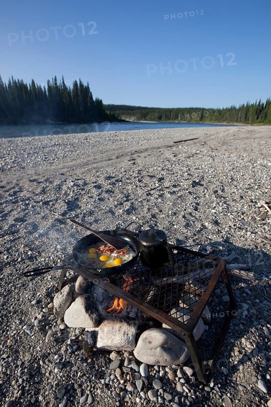 cooking / frying bacon and eggs on a camp fire
