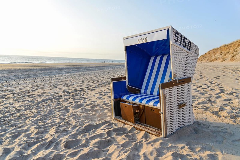 Roofed wicker beach chair on the beach
