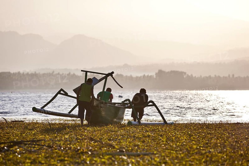 Fisherman with a fishing boat with outriggers