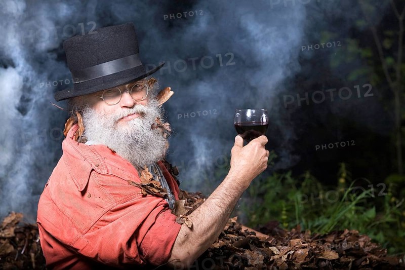 Elderly man with a long beard wearing a top hat and glasses