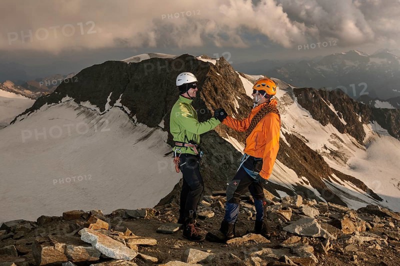 Mountain climbers congratulating one another following the ascent to the summit of Wilder Pfaff Mountain