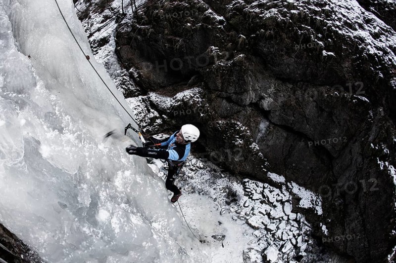 Ice climber climbing a frozen waterfall