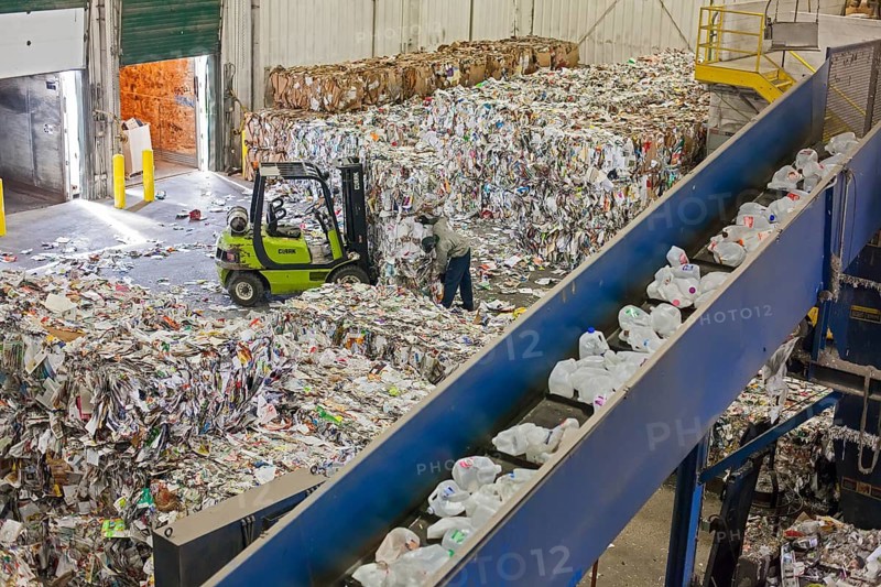 Low-wage workers sort paper