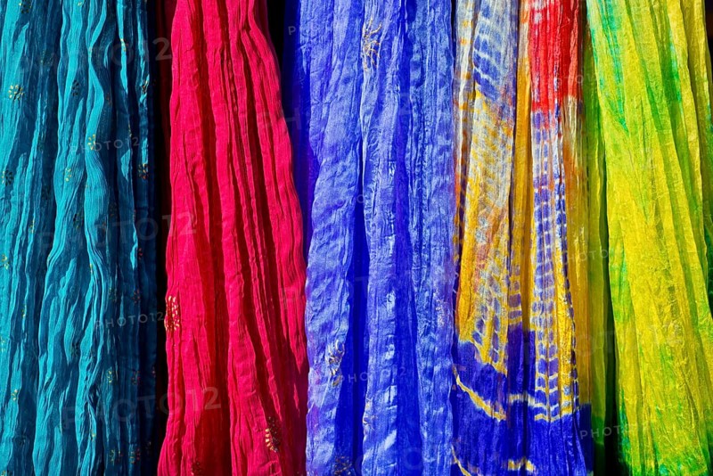 Colourful silk scarves are displayed for sale