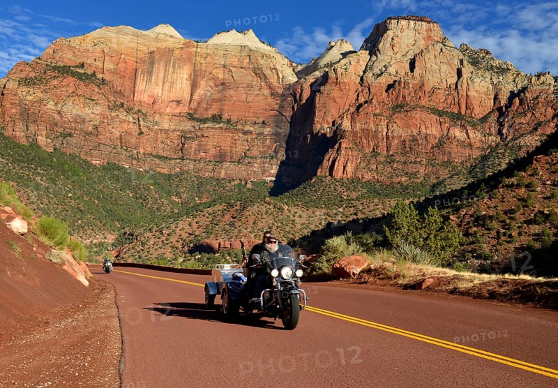 Harley Davidson motorcycle on the red road of Zion Park Boulevard - Mount Carmel U.S. Highway 9