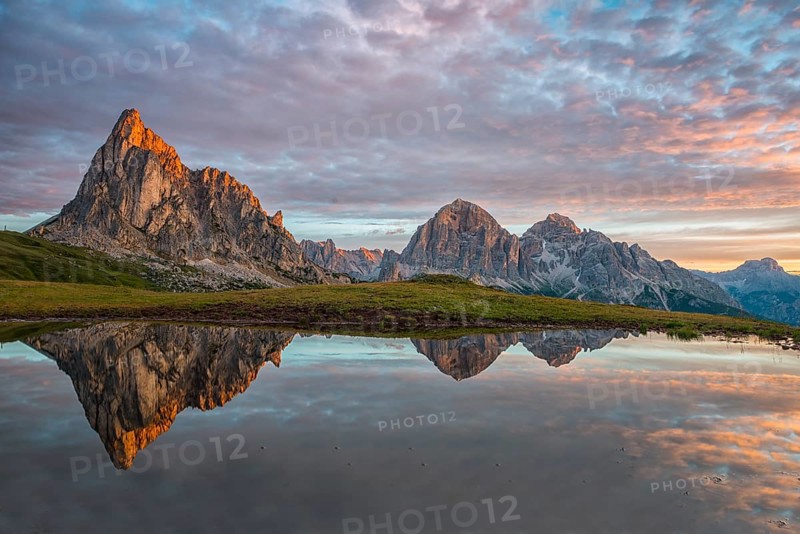 Gusela mountain at sunrise reflected in small lake