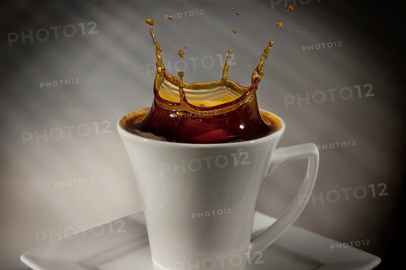 Sugar cube falling into a cup of coffee