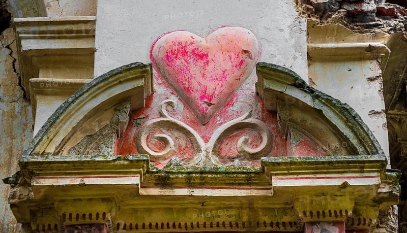 Heart carved in a wall in the ruins of a church