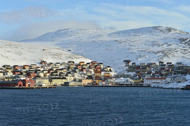 Buildings at the harbour in front of the mountains of the island