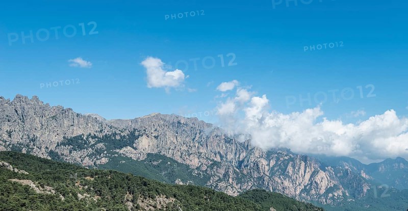 Cliffs and rocks in front of clouds