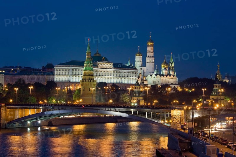 Moscow Kremlin with cathedrals and palace and Bolshoy Kamenny Bridge on Moskva River at night