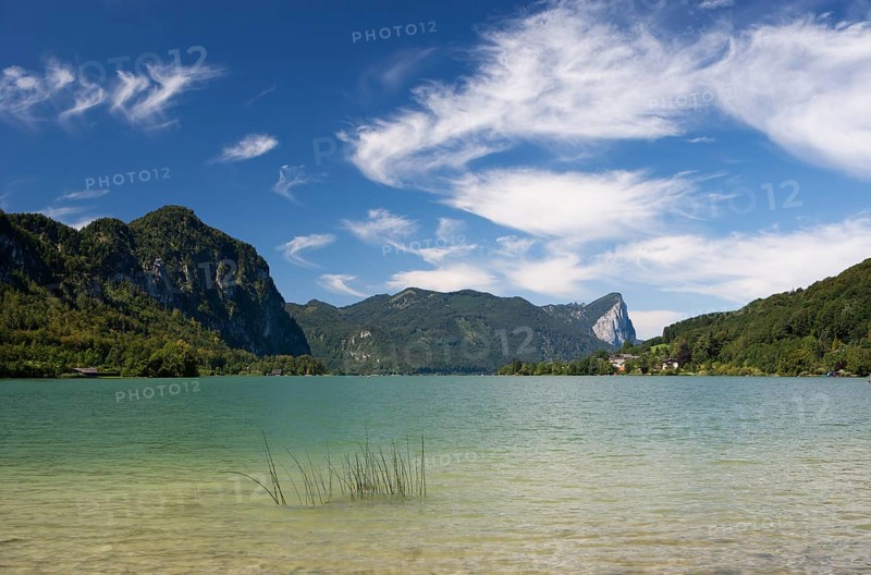 Mondsee lake with Drachenwand rock wall at the back