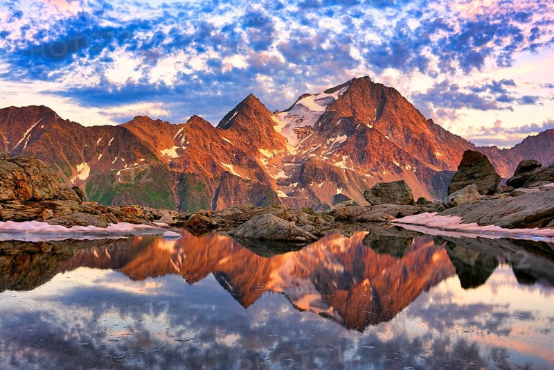 Reflection of the Oberalpstock in a mountain lake