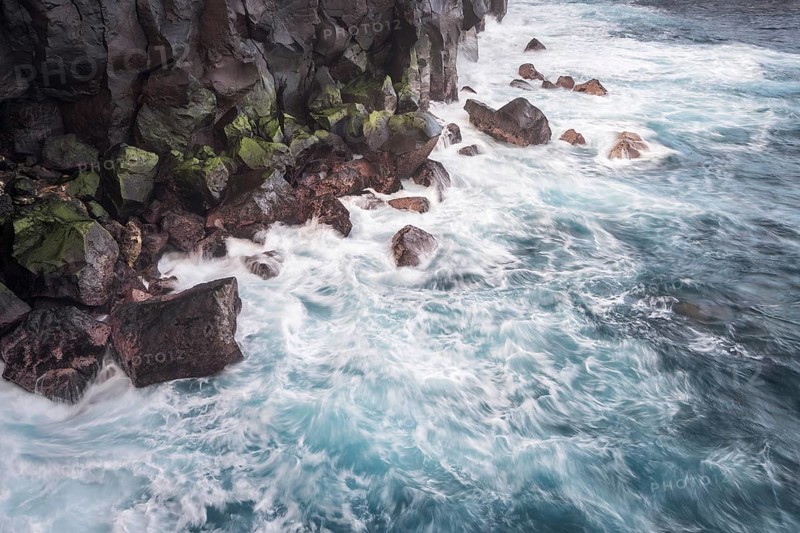 Waves of a stormy sea on the rocky coast at Cap Mechant